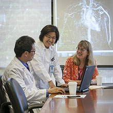 a picture of clinicians sitting at a desk